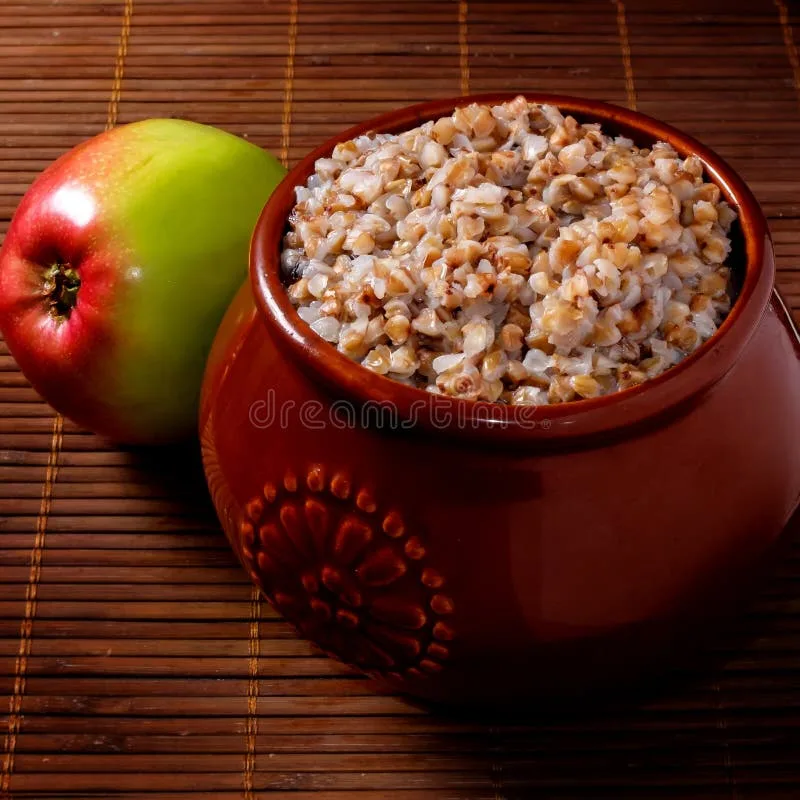 Creamy buckwheat porridge topped with stewed apple slices and scattered almonds
