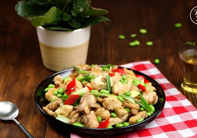 Chicken and edamame stir-fry with colorful vegetables in a glossy sauce