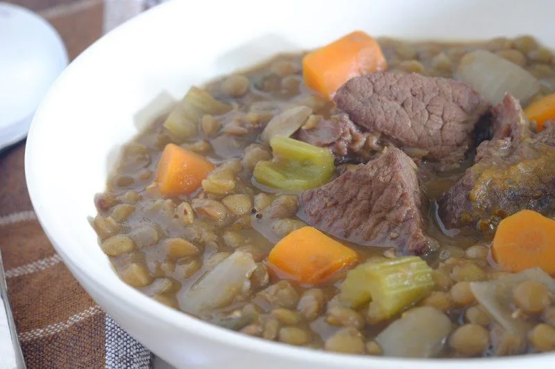 Hearty beef and lentil stew with vegetables served in a rustic bowl
