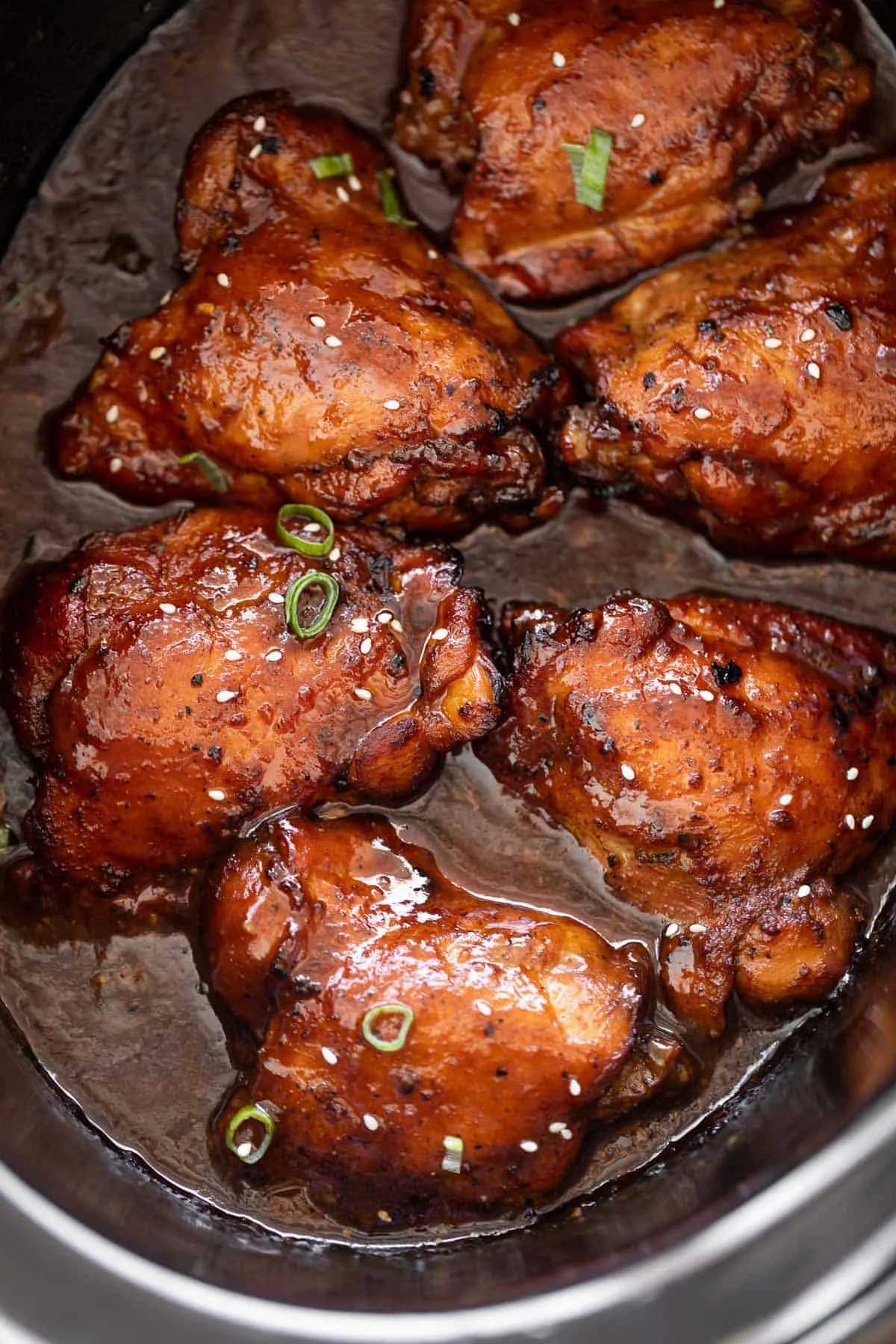 Glazed chicken thighs in a rich honey garlic sauce in a slow cooker