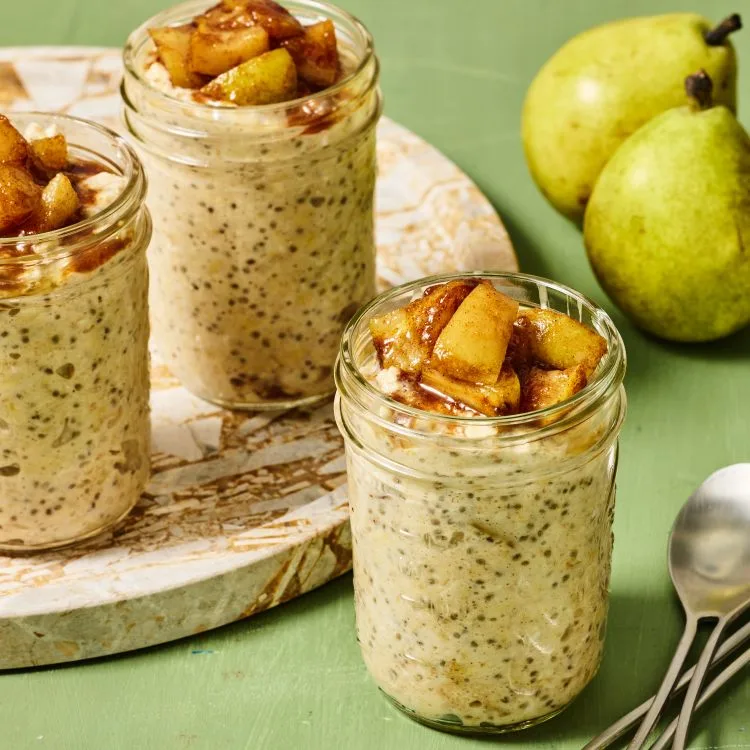 Creamy overnight oats topped with sliced pear and a sprinkle of cinnamon