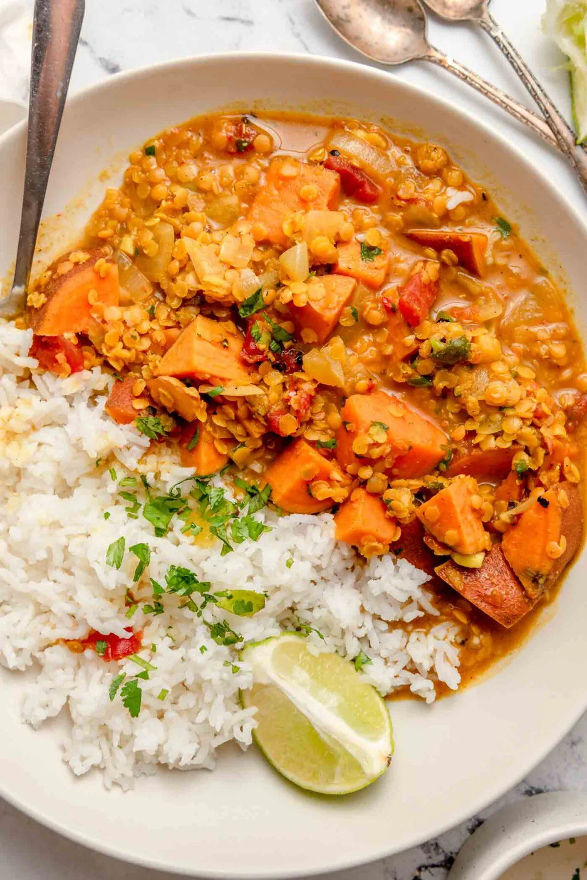 A bowl of red lentil and sweet potato curry with warm golden sauce