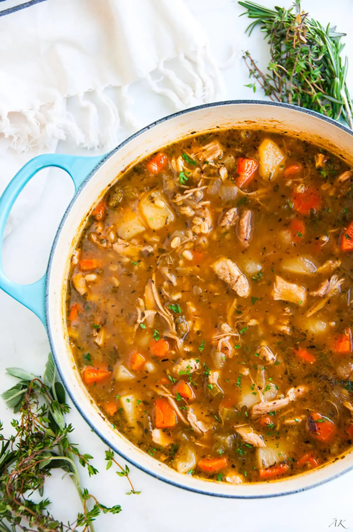 Hearty chicken and barley stew with vegetables in a rustic bowl