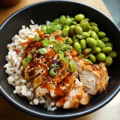 Slow cooker chicken served over rice with edamame in a bowl