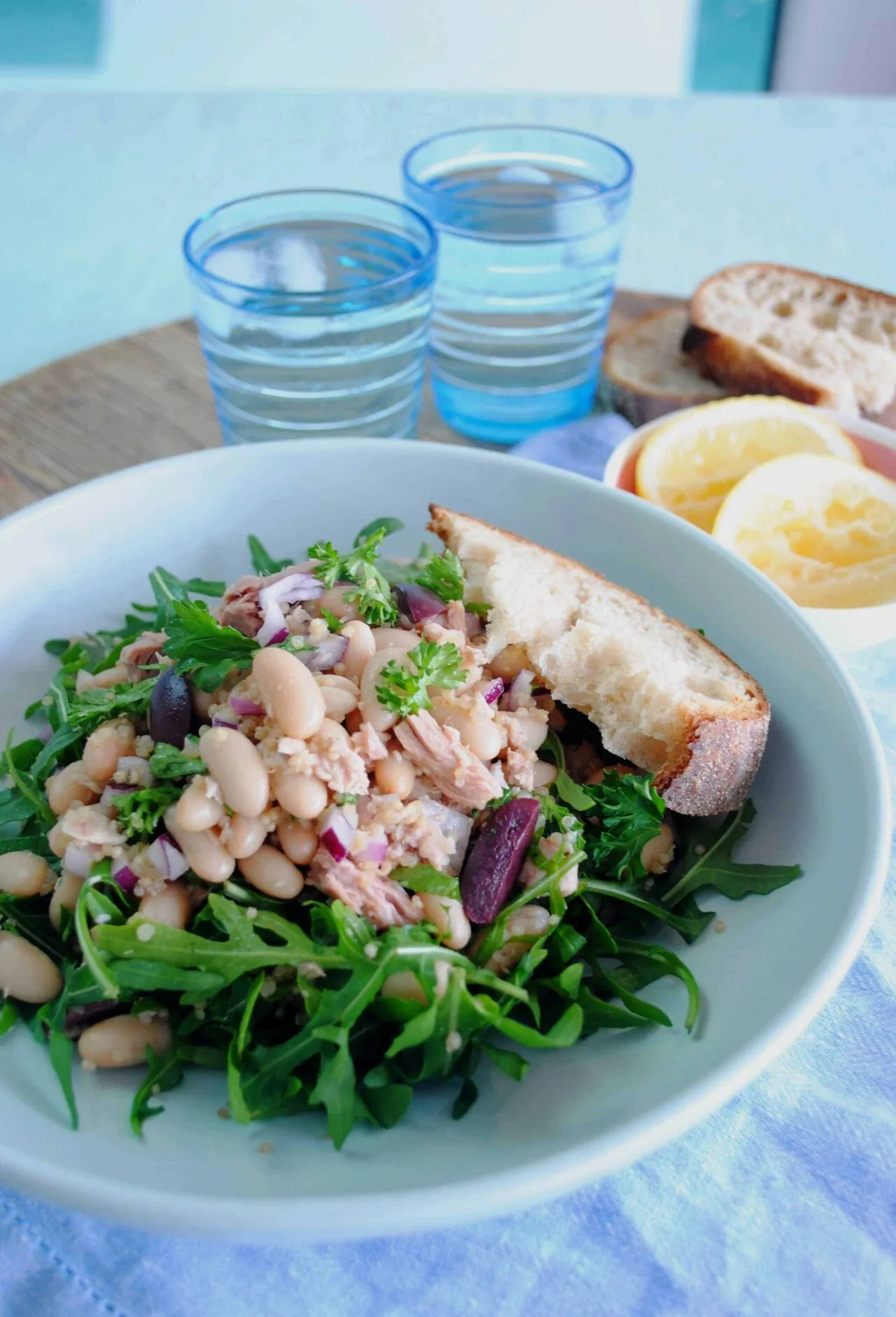 Tuna and cannellini bean salad with fresh herbs in a white bowl
